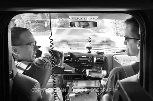 two emts in the front of the ambulance driving