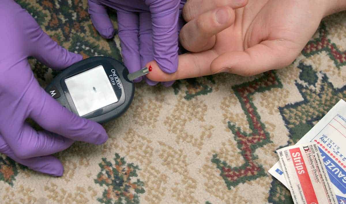 EMT taking a patient's blood sugar levels