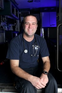 emt smiling in back of ambulance