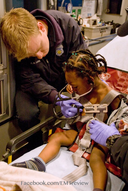 EMT assessing toddler with stethoscope