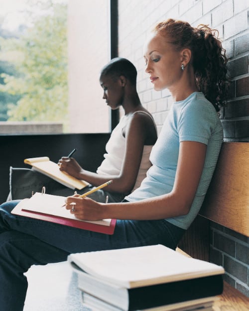 two women writing notes