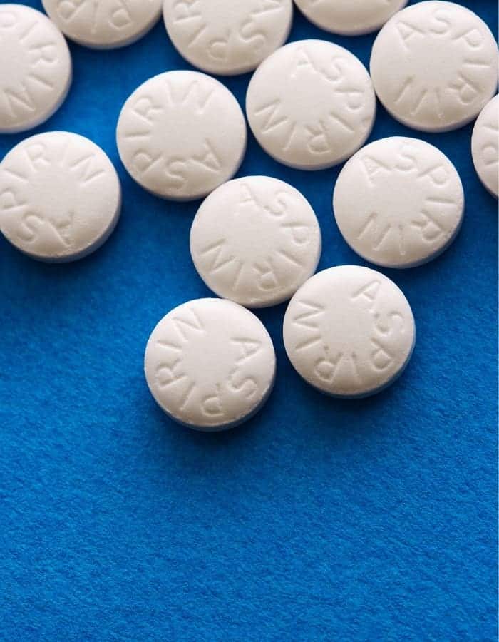 aspirin pills on blue background