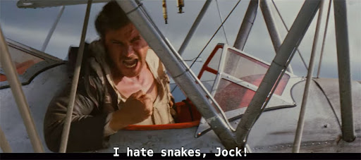 Indiana Jones on airplane with text "I hate snakes, Jock!"