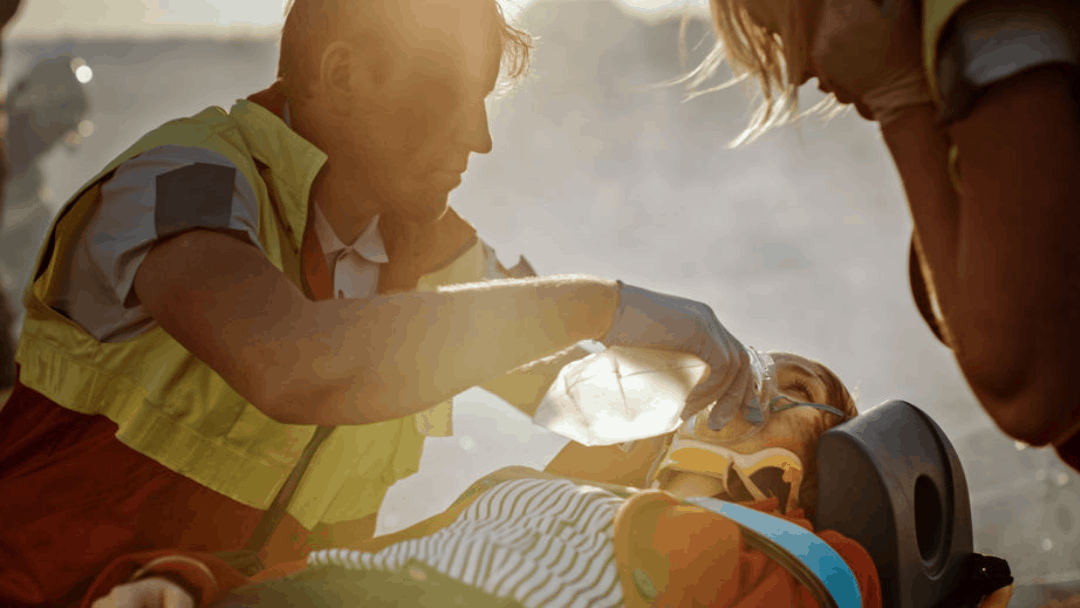 trauma scene with emt administering oxygen