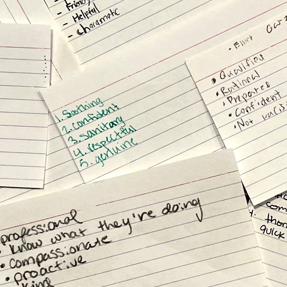 closeup of handwritten notecards from EMT students defining the qualities they want in an EMT