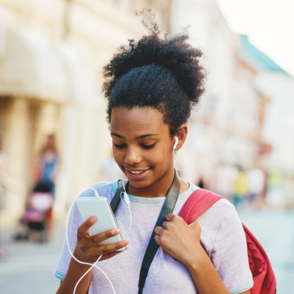 girl with headphones connected to phone