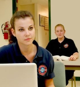two female EMT students sitting in class
