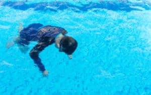 Young boy drowning in the pool