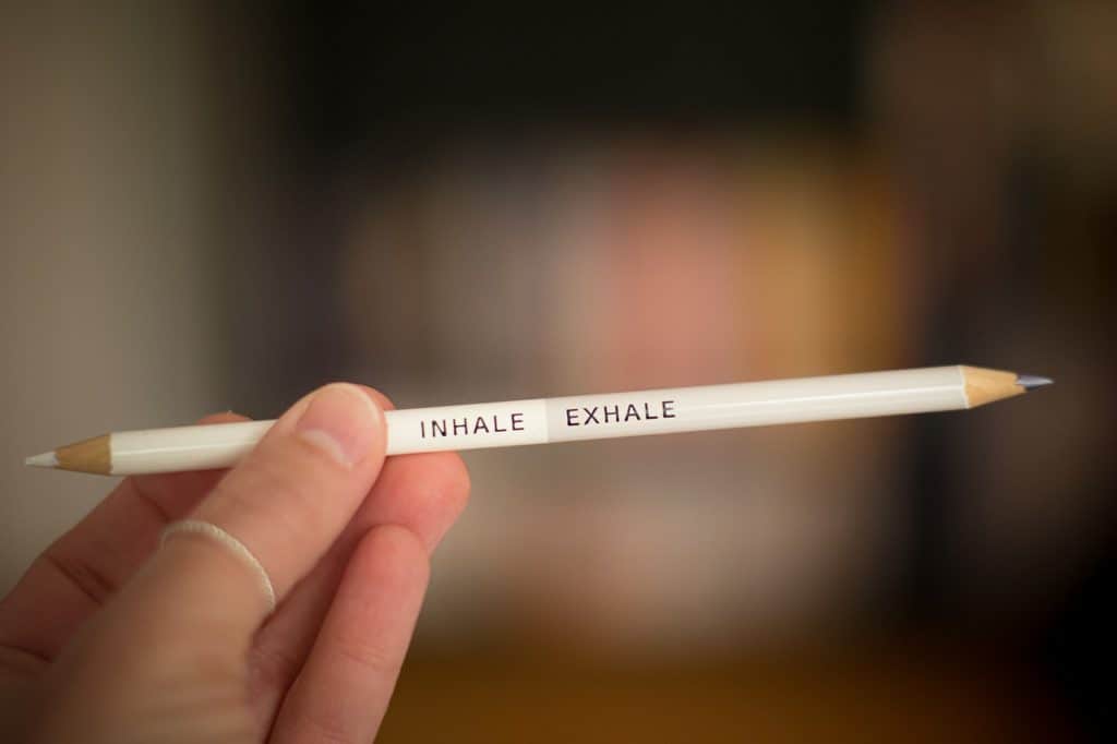 white pencil that says "inhale" on the left side and "exhale" on the right side