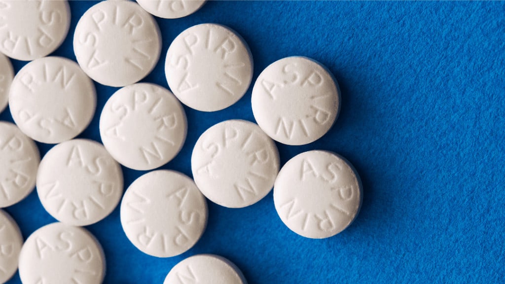 aspirin pills on blue background