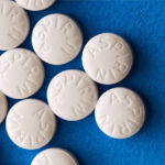 aspirin pills on blue background