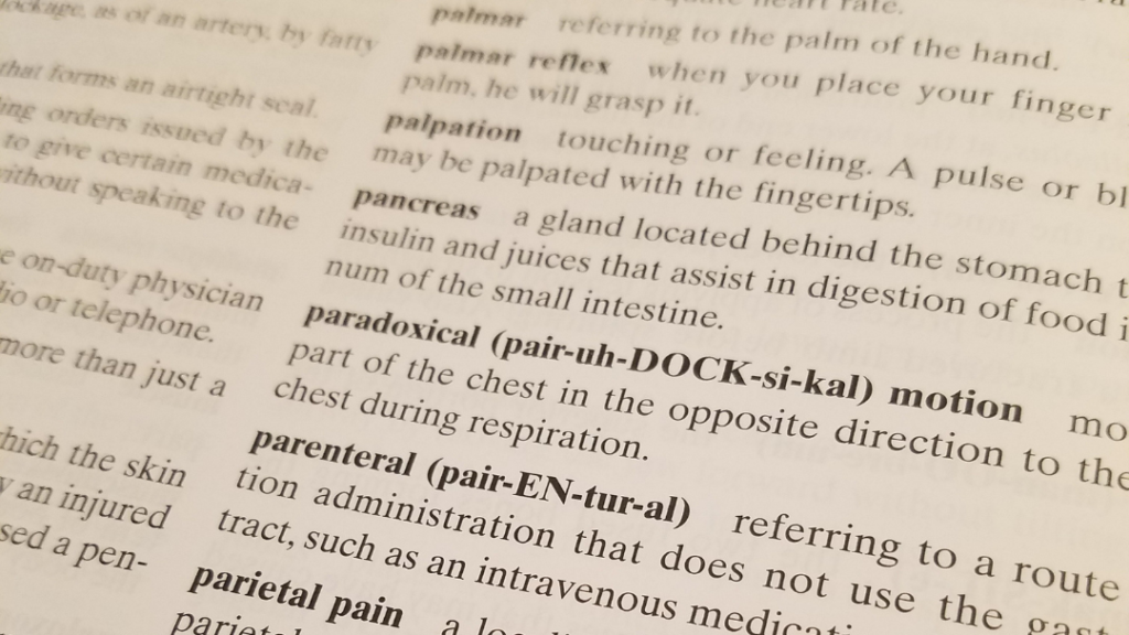 Emergency care textbook glossary showing medical terms like parenteral
