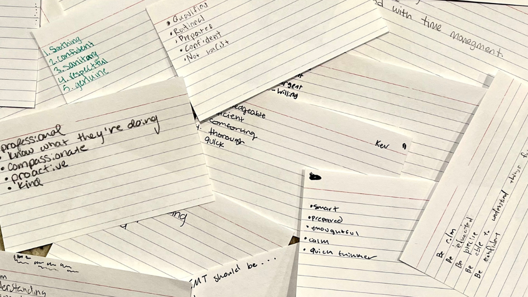 handwritten notecards from EMT students defining the qualities they want in an EMT